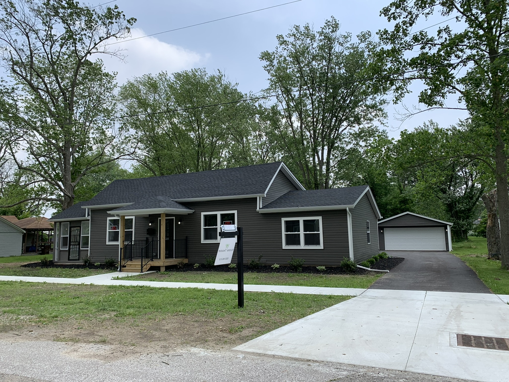 Finished exterior — new roof, siding and porch by Resolute Construction and Remodel