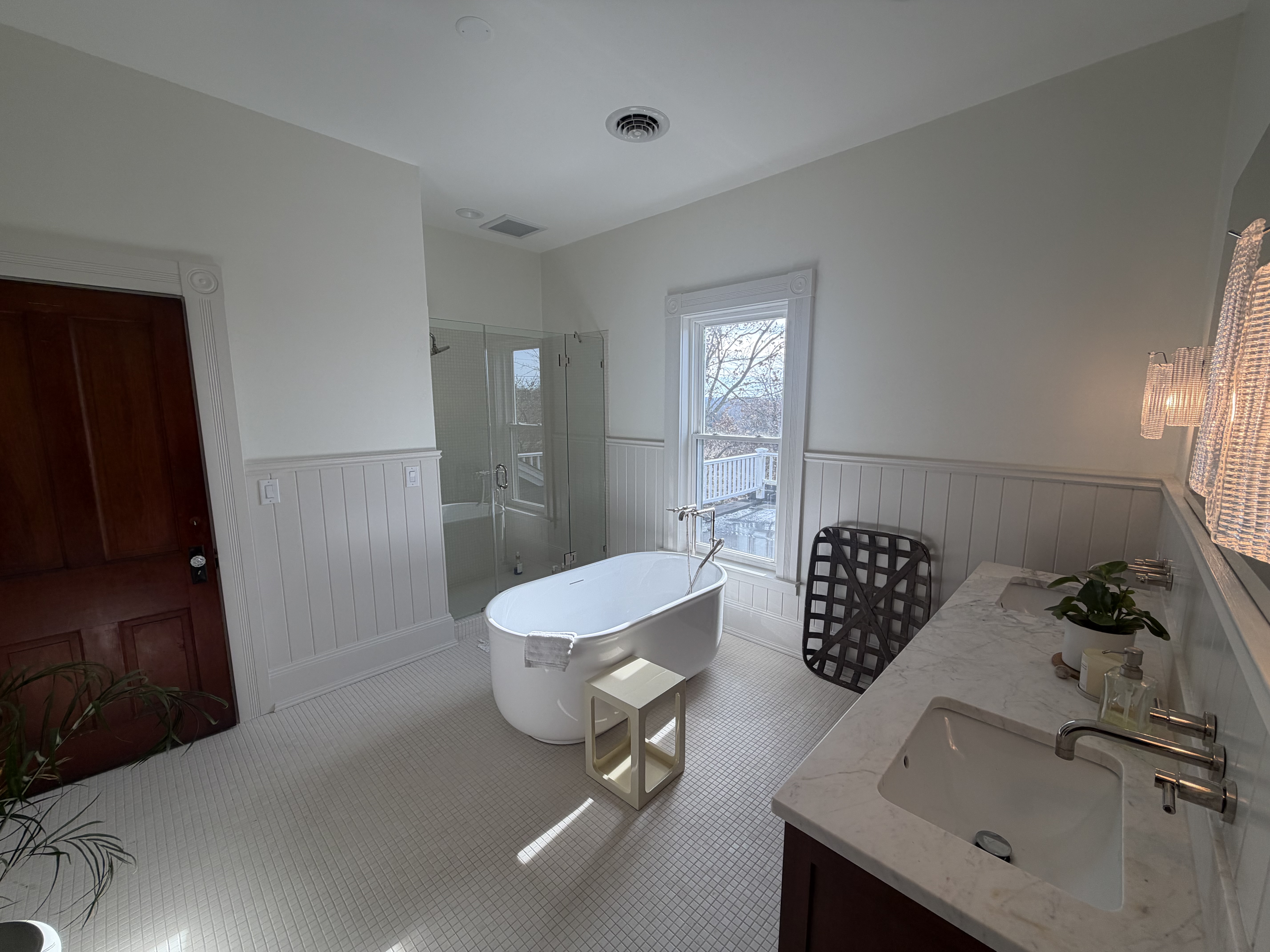 Spa bath with freestanding tub and beadboard wainscoting by Resolute Construction and Remodel
