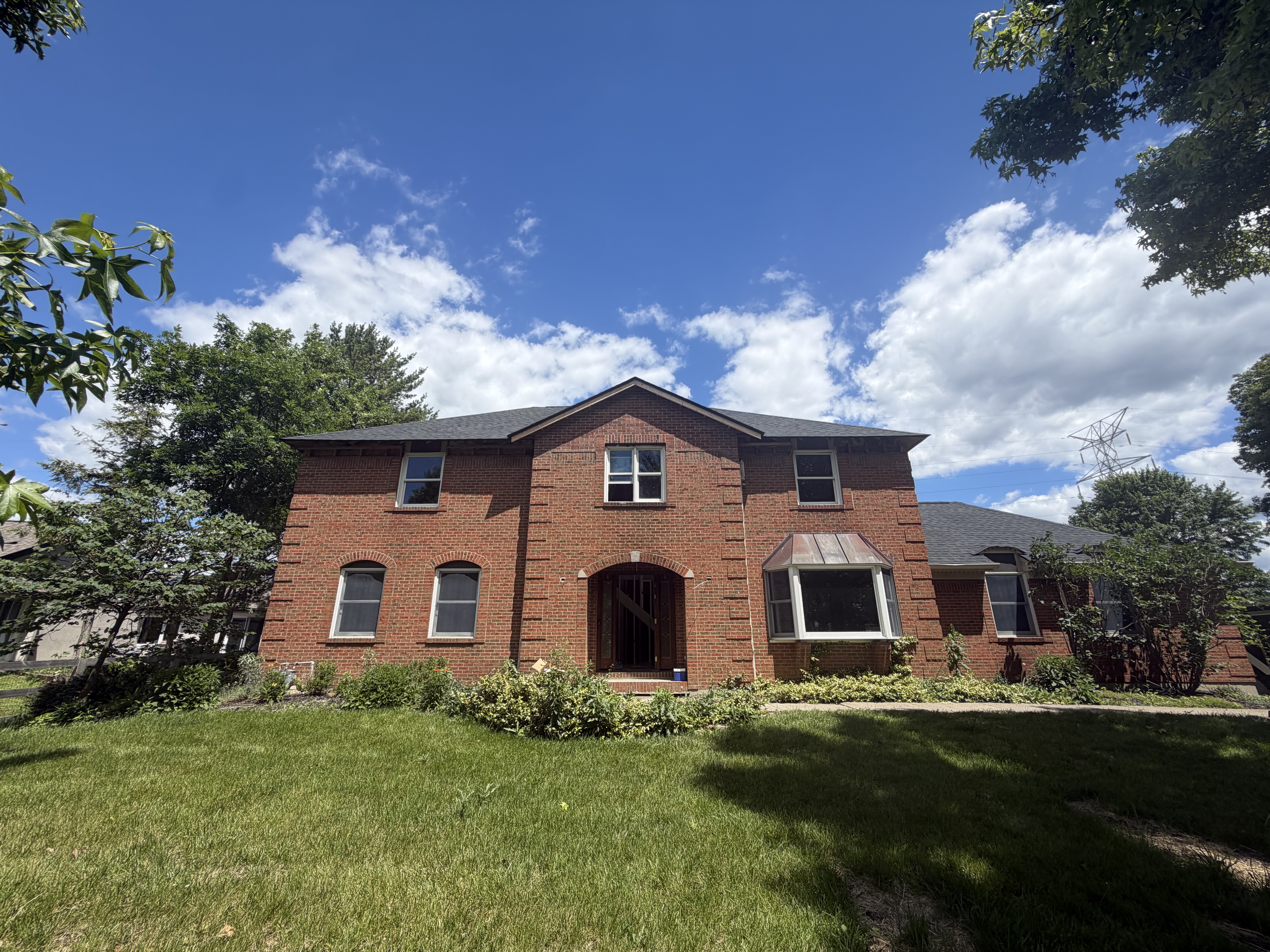 Restored brick two-story home by Resolute Construction and Remodel