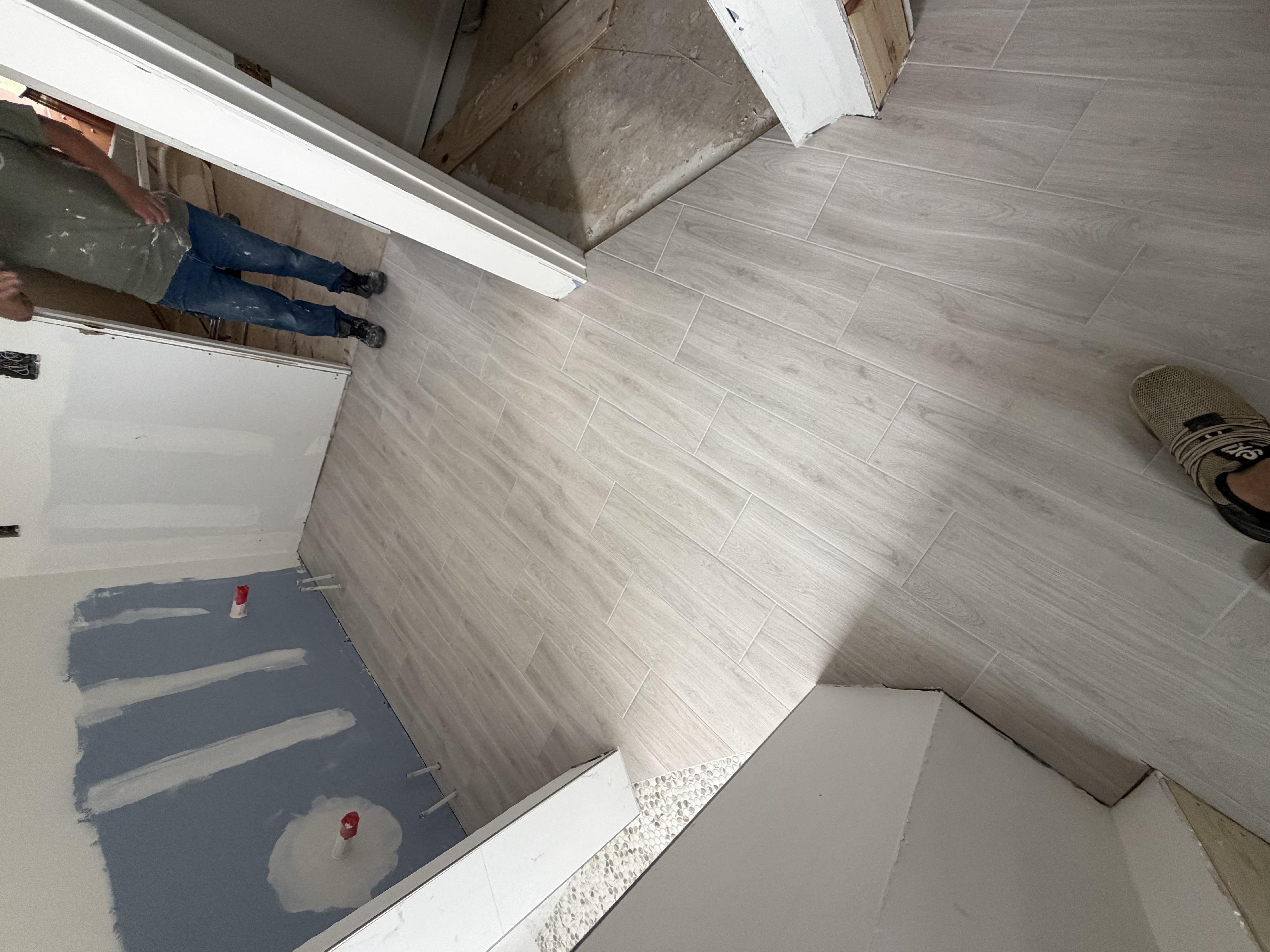 Wood-look plank tile flooring by Resolute Construction and Remodel
