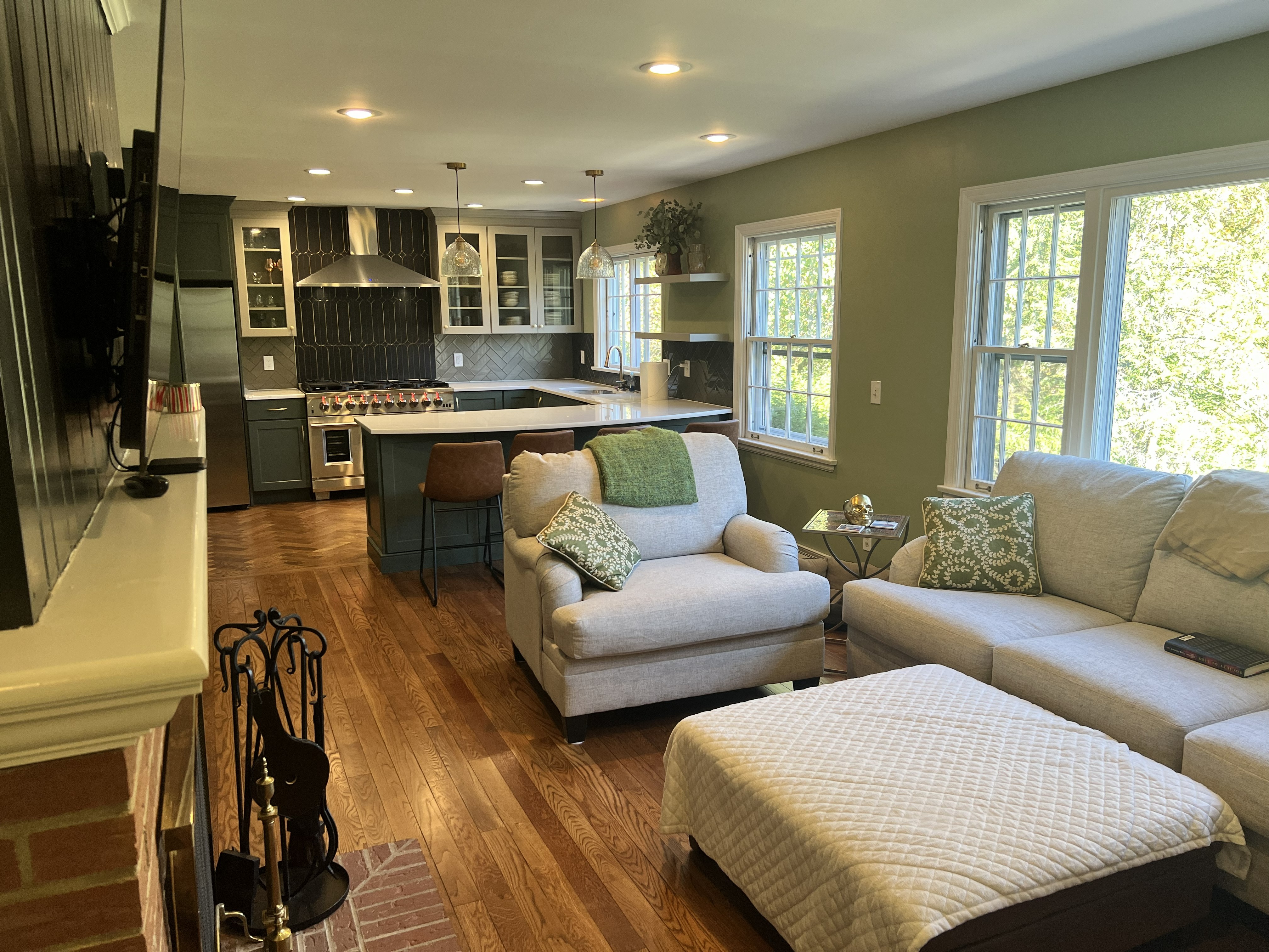 Kitchen opening into the living space by Resolute Construction and Remodel