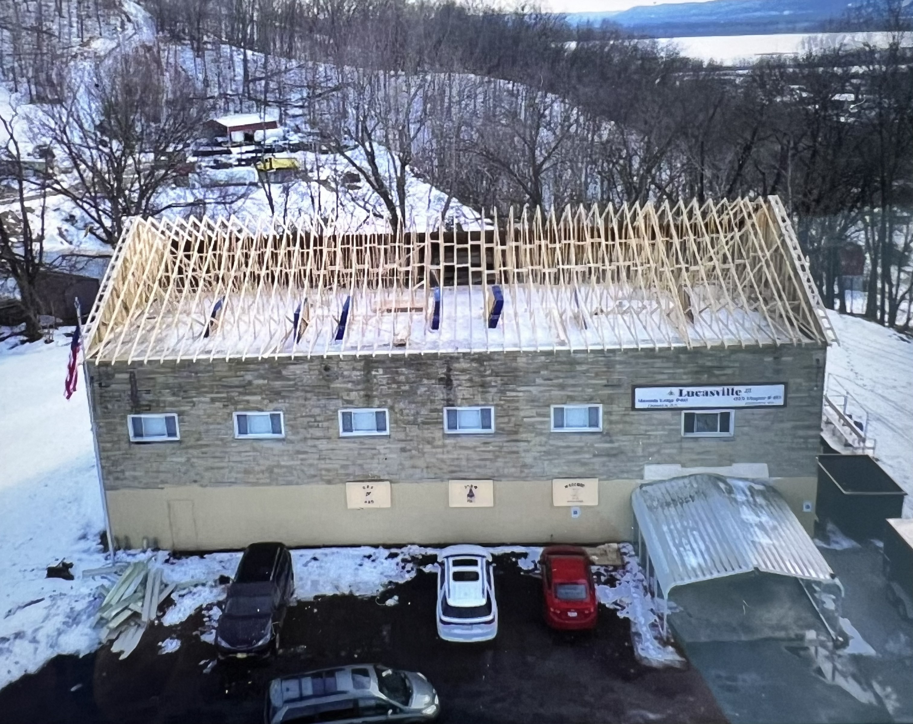 New roof structure and trusses framed and set on a building by Resolute Construction and Remodel