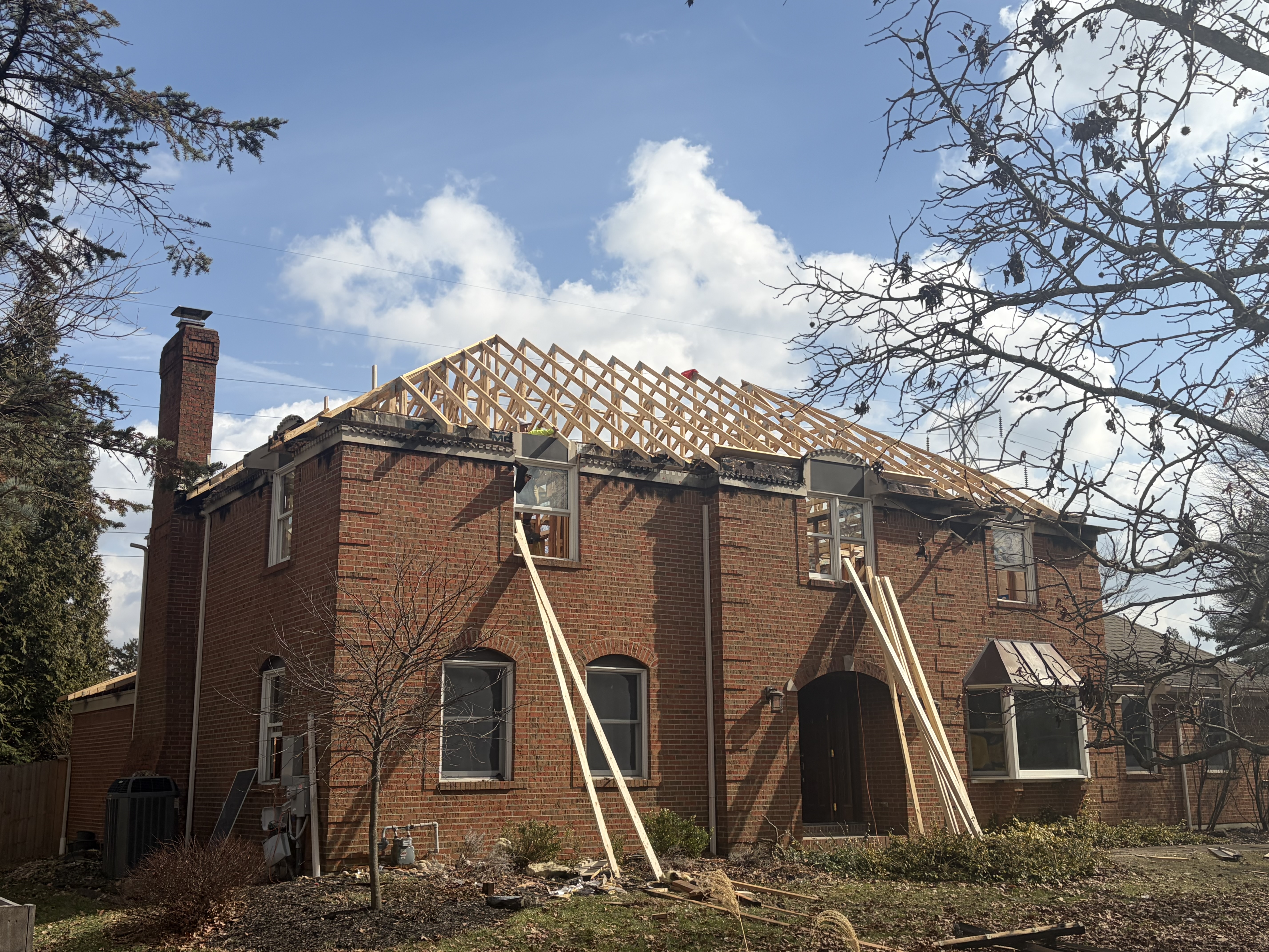 Brand-new roof framed on the original brick by Resolute Construction and Remodel